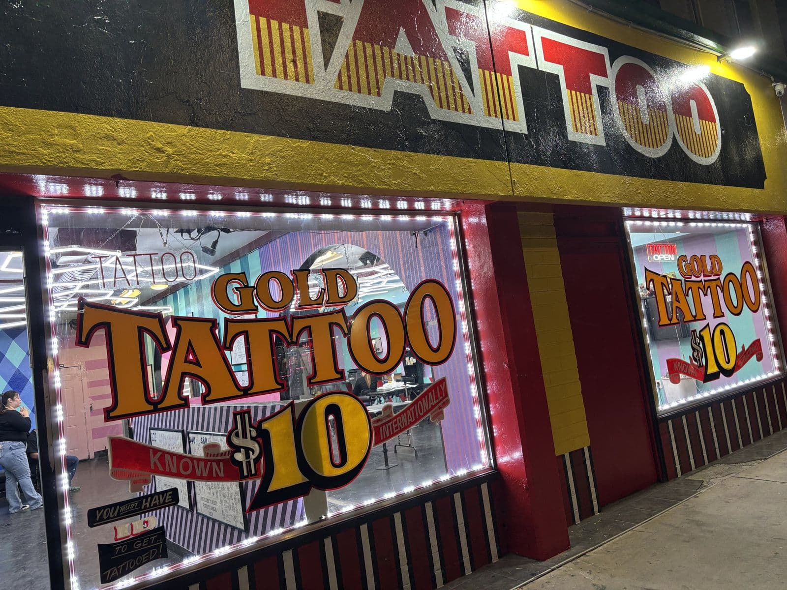 Lit front windows of Gold Tattoo Vegas at 1506 S Las Vegas Blvd at night